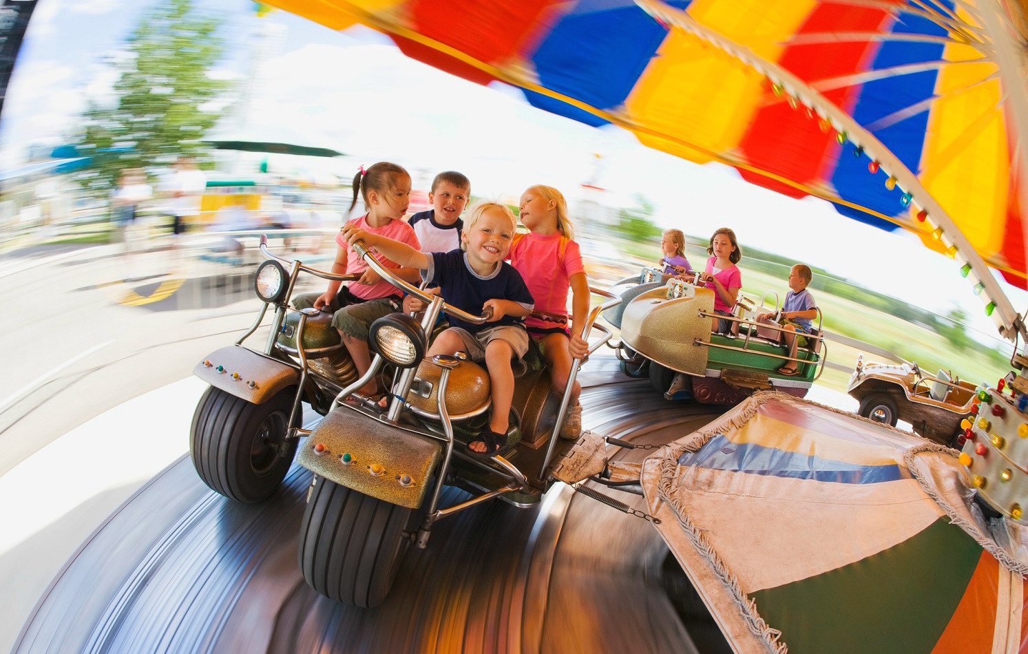 Kids on a ride at an amusement park.