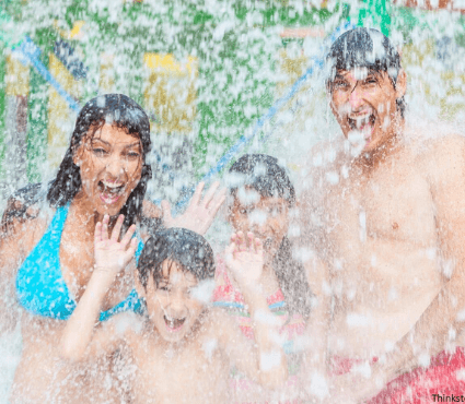 family getting splashed at the water park