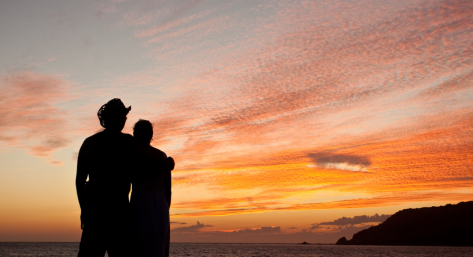 couple hugging at a beach sunset