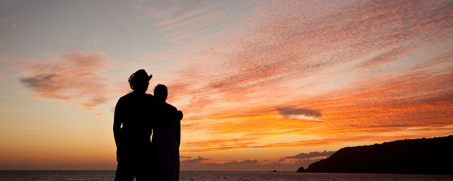 couple hugging at a beach sunset