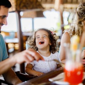 family enjoying dining out at a restaurant near Barefoot Landing