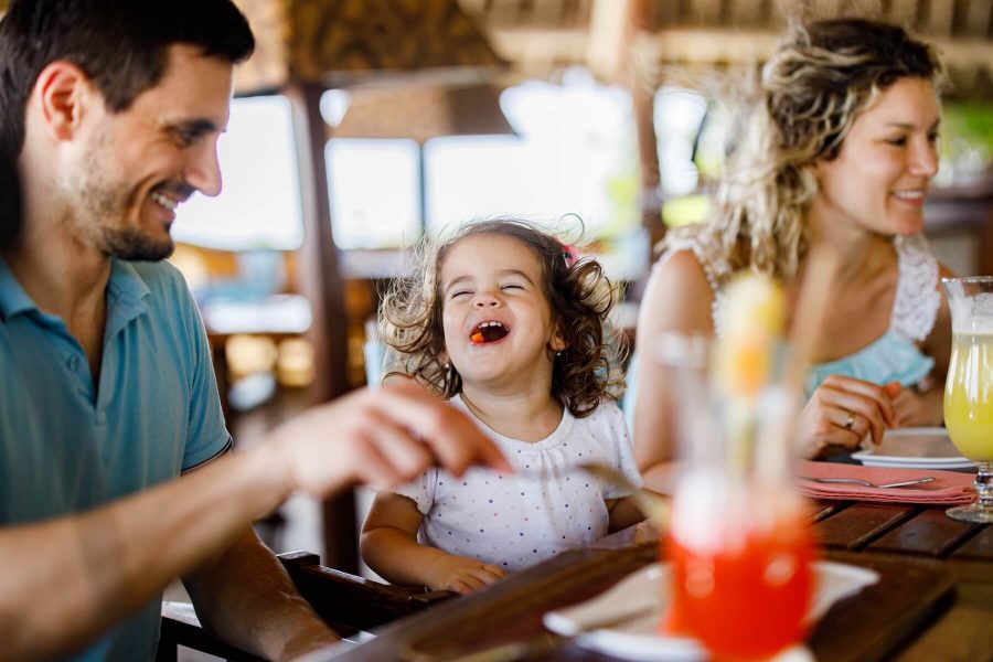 family enjoying dining out at a restaurant near Barefoot Landing