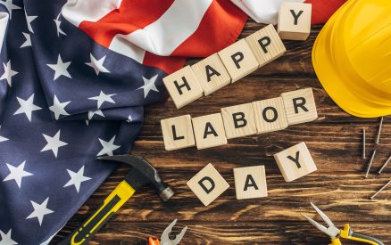 top view of american flag and instruments near safety helmet and happy labor day lettering on wooden surface